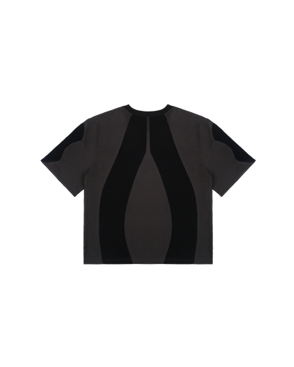 Freigestelltes schwarzes T-Shirt mit symmetrisch eingesetzten dunkelgrauen Stoffbahnen auf Rücken und Ärmeln. Die Panelstruktur betont die Körpermitte visuell durch vertikale Formlinien.